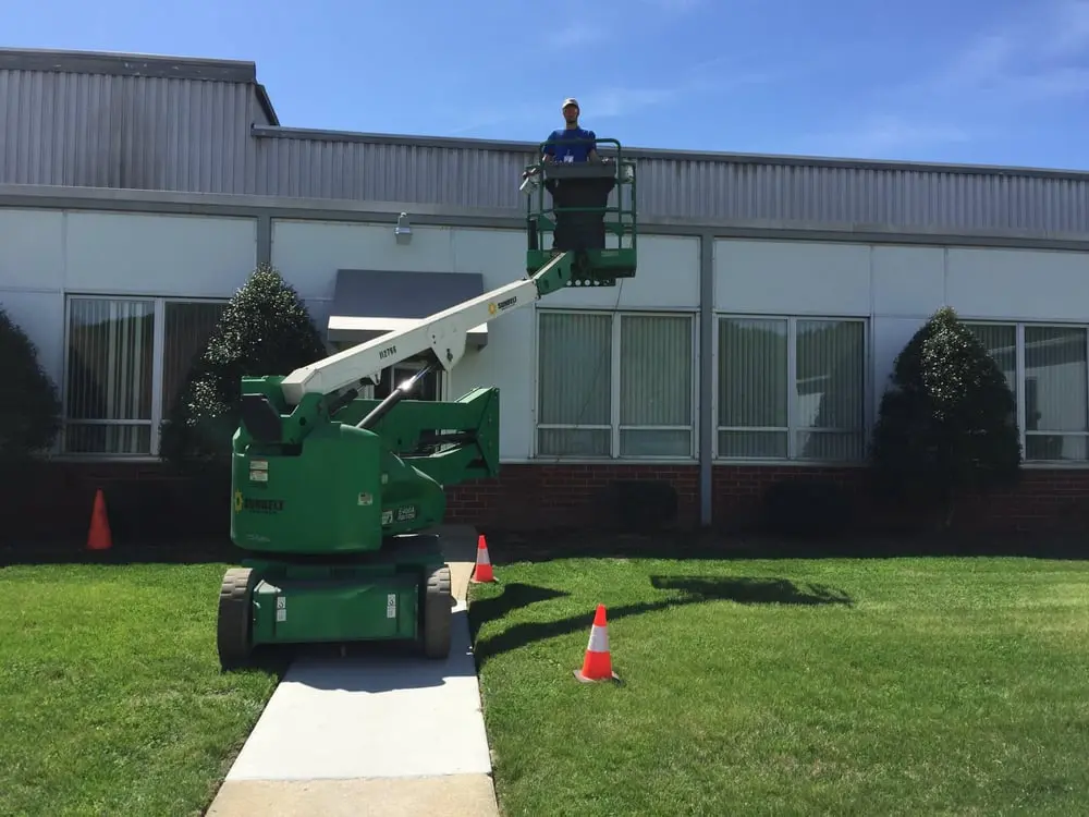 Appalachian HVAC technician using a lift for commercial HVAC service